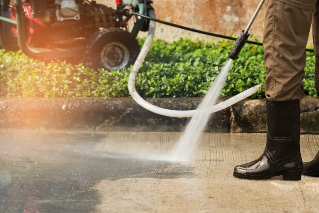 High Pressure Deep Cleaning. Worker Cleaning Driveway With Gasol